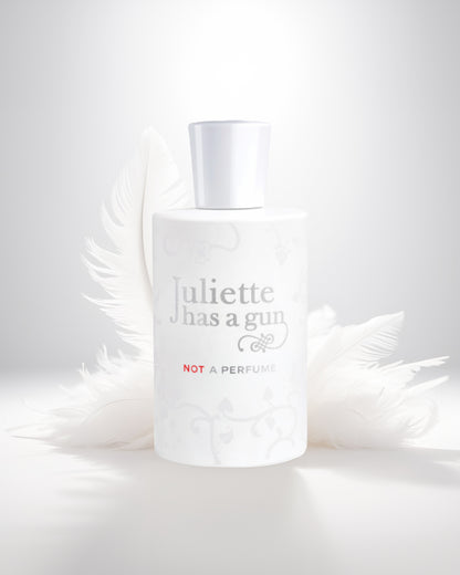 Not a perfume edp perfume bottle photograph against white feather
