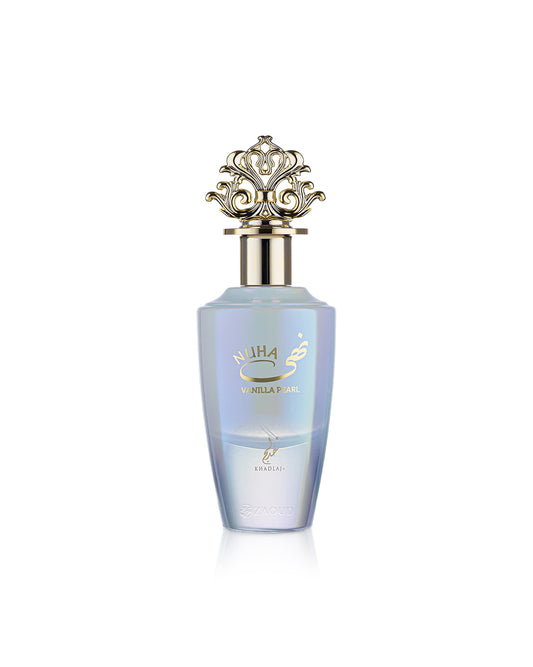A bottle of nuha Vanilla pearl perfume with a light blue iridescent body, gold lettering, and an ornate gold cap, set against a plain white background.
