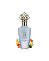 A bottle of nuha Vanilla pearl perfume with a light blue body, gold lettering, and an ornate gold cap, styled with small flowers and berries on a white background.