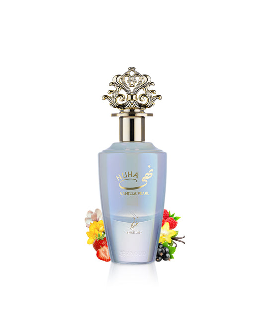 A bottle of nuha Vanilla pearl perfume with a light blue body, gold lettering, and an ornate gold cap, styled with small flowers and berries on a white background.