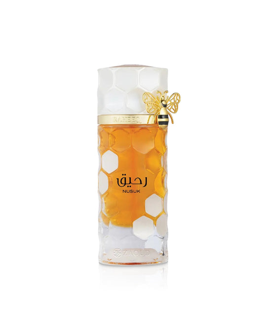 nusuk raheeq Perfume bottle with honeycomb design and bee decoration on a white background