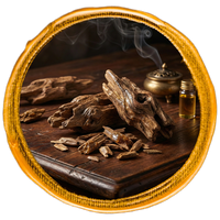 agarwood oud chips on a wooden surface with a bottle of oil and incense burner, framed by a decorative border.