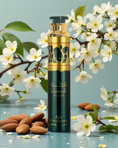 qimmah for women air freshener bottle photograph beside almond beside white flowers against blue surface and background