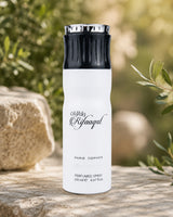A white cylindrical perfume spray bottle with a black ribbed cap and silver metal top, standing on a stone surface with a blurred outdoor garden background.