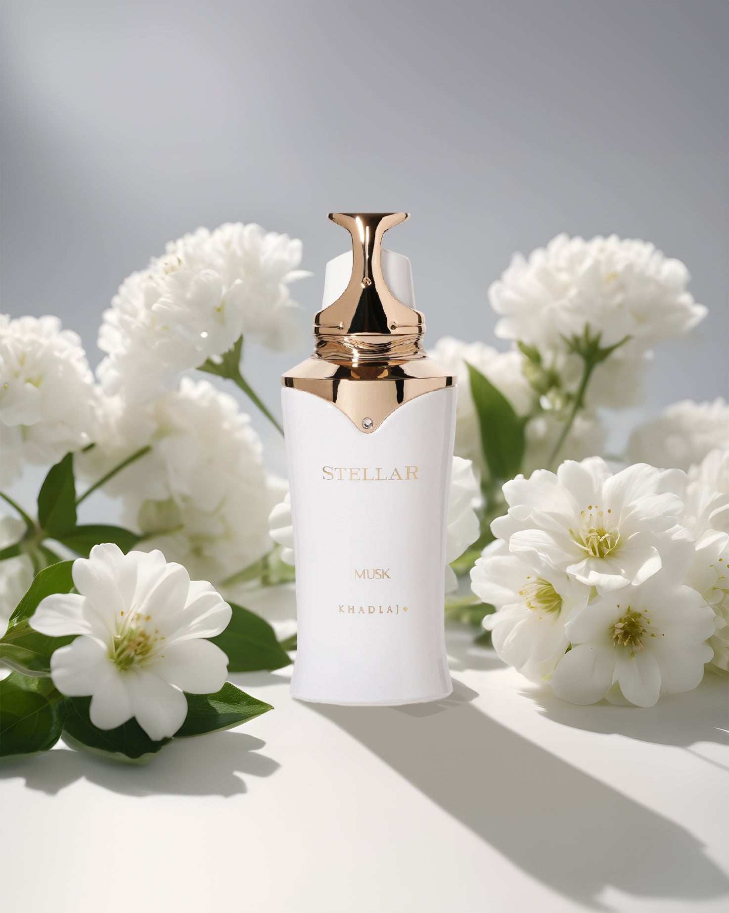 STELLAR MUSK edp perfume bottle photograph between white musk flowers