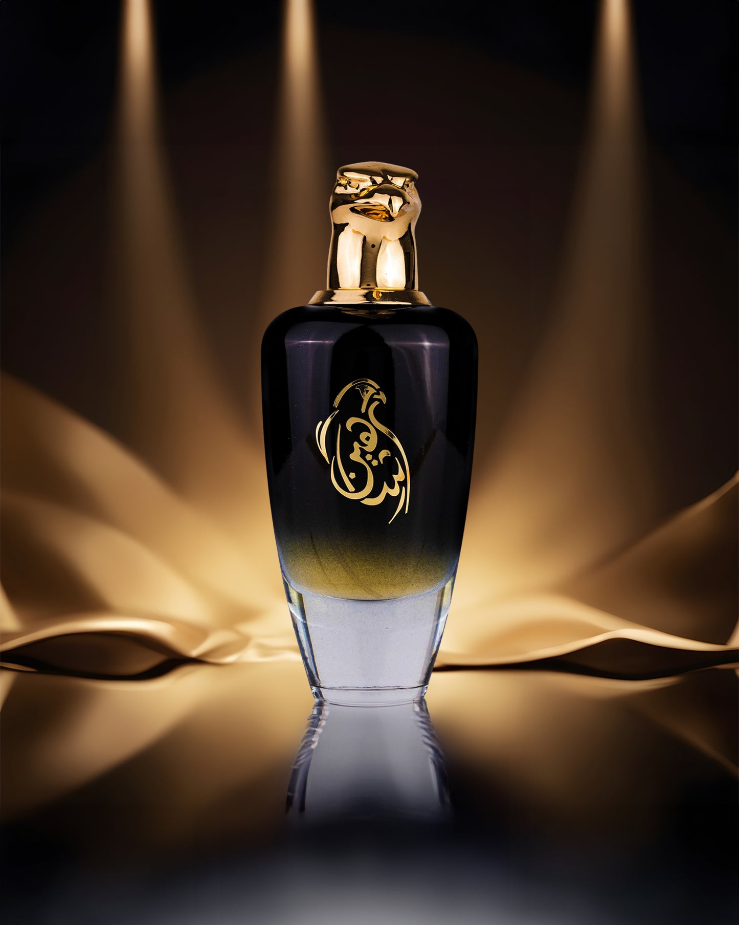 shaheen black edp by maison asrar black colour perfume bottle photograph over a reflected surface against brown colour stage light from up and down.