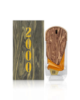 the roots 2000 perfume bottle shows beside its packaging against white background