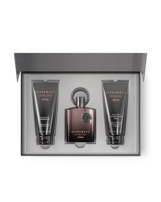 A three-piece men's grooming gift set by Afnan, featuring a central bottle of Supremacy for Men cologne and two matching body care tubes (Body Wash and Soothing After Shaver) arranged inside an open gray presentation box.
