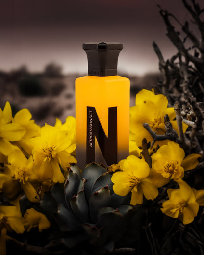 african sunset aqua parfum bottle surrounded by yellow cactus flower