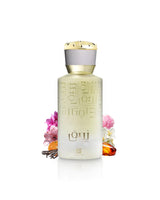 ahmed al maghribi zuraique perfume bottle surrounded with flowers and amber shows against white background