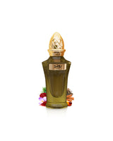 ahmed al maghribi rawdha Green perfume bottle with gold cap surrounded by saffron and amber on a white background