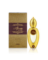 A bottle of Ajmal wisal dhahab perfume next to its textured gold and dark purple box, displayed on a clean white background with a soft reflection.