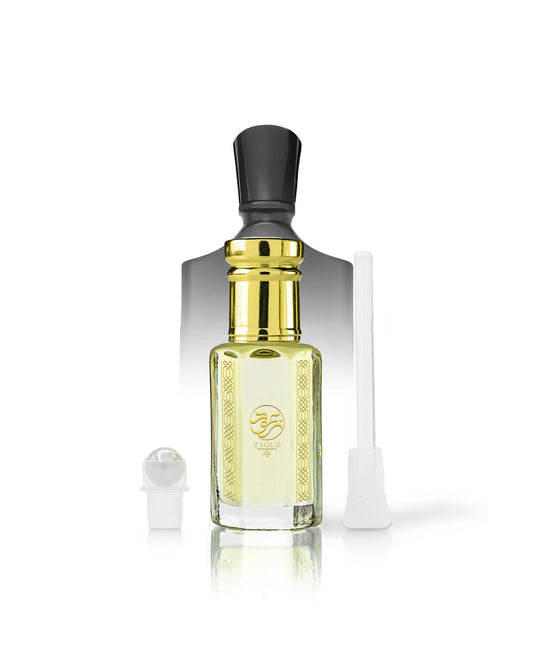 ananas absolu perfume oil bottle with pale yellow liquid, a shiny gold neck, a black cap, and a gold logo on the front. A small white spray atomizer and a white applicator tube are placed beside it on a clean white background.