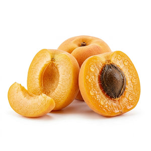 Four ripe apricots on a white background, including two halves and one whole fruit, with one slice leaning against the front half. The apricots are golden orange-yellow with a dark brown pit and visible water droplets.