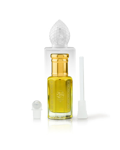 arabian mango Perfume oil bottle with gold cap beside roller and stick with clear cap on a white background