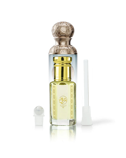 arabian wadi perfume oil bottle beside roller and stick with gissah imperial valley bottle behind shows against white background