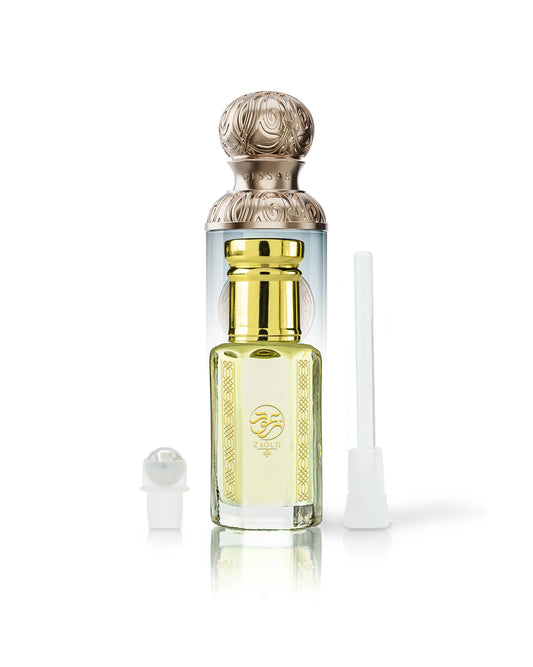 arabian wadi perfume oil bottle beside roller and stick with gissah imperial valley bottle behind shows against white background