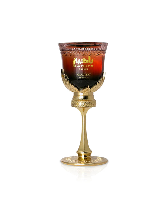 arabiyat prestige Bahiya Garnet Decorative glass with gold base and red liquid on a white background