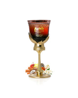 arabiyat prestige Bahiya Garnet Decorative glass with gold base and 'Arabiyat' branding surrounded by fruits on a white background
