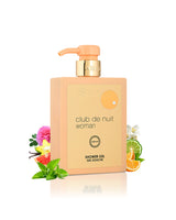 armaf club de nuit woman shower gel bottle surrounded with orange and vanilla  shows against white background