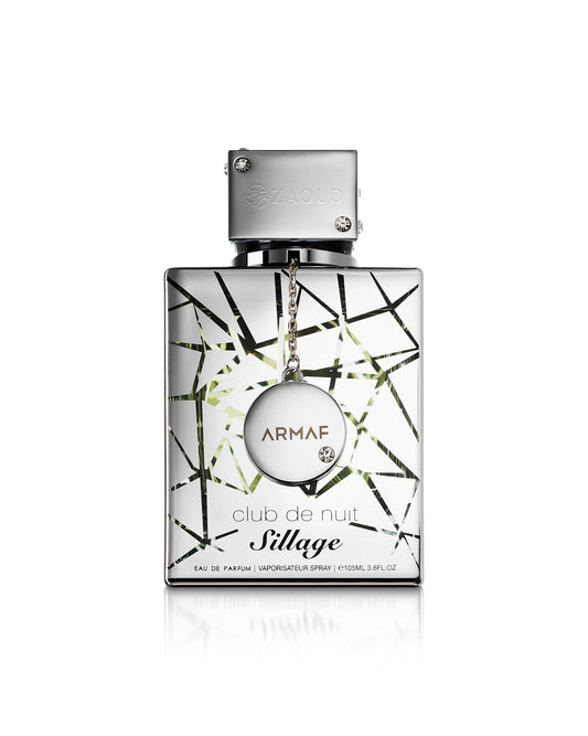 Armaf Club de Nuit Sillage Eau de Parfum bottle, featuring a silver rectangular glass body with a black and green geometric line pattern, a silver cap, and a hanging silver medallion with the brand name 'ARMAF' on a white background.