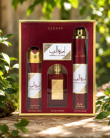 Asdaaf ameerat al arab gift set in a red and gold box, containing a perfume spray, a perfume air freshener, and a perfume spray bottle photograph in nature