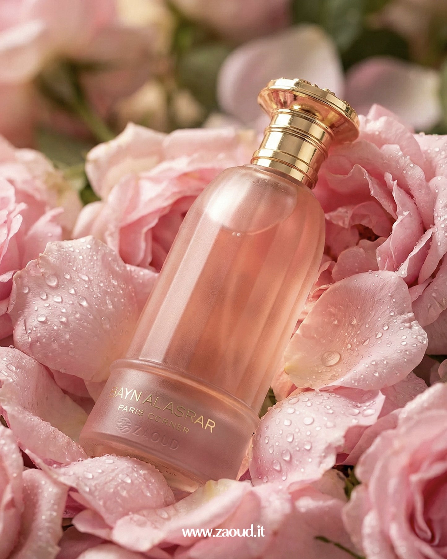 bayn al asrar by paris corner  Perfume bottle with gold cap on pink flowers