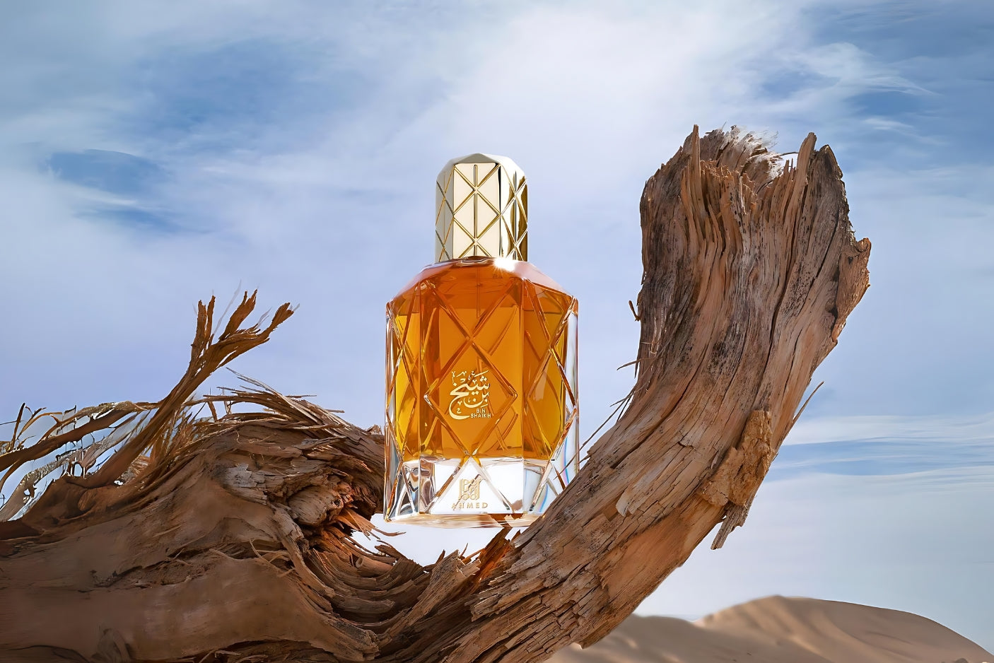 bin shaikh ahmed al maghribi perfume bottle photograph in desert over woodlog