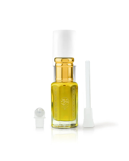 caramel 71 perfume oil bottle with golden cap beside roller and stick shows against white backgrund