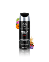 A bottle of Urban Men Club de Nuit Elixir perfume body spray by Armaf, presented on a reflective white surface with decorative citrus and flowers around the bottle.