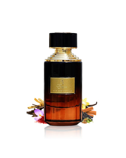 emir oud and vanille Perfume bottle with black cap and gold accents surrounded by saffron and cardamom on a white background
