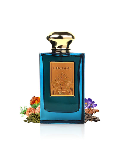 enamor by riiffs perfume bottle surrounded with its ingredients like cardamom and amber with many others shows from behind the bottle against white background