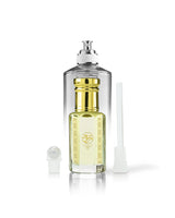 firewood perfume oil bottle beside roller and stick with by the fireplace perfume bottle behind shows against white background