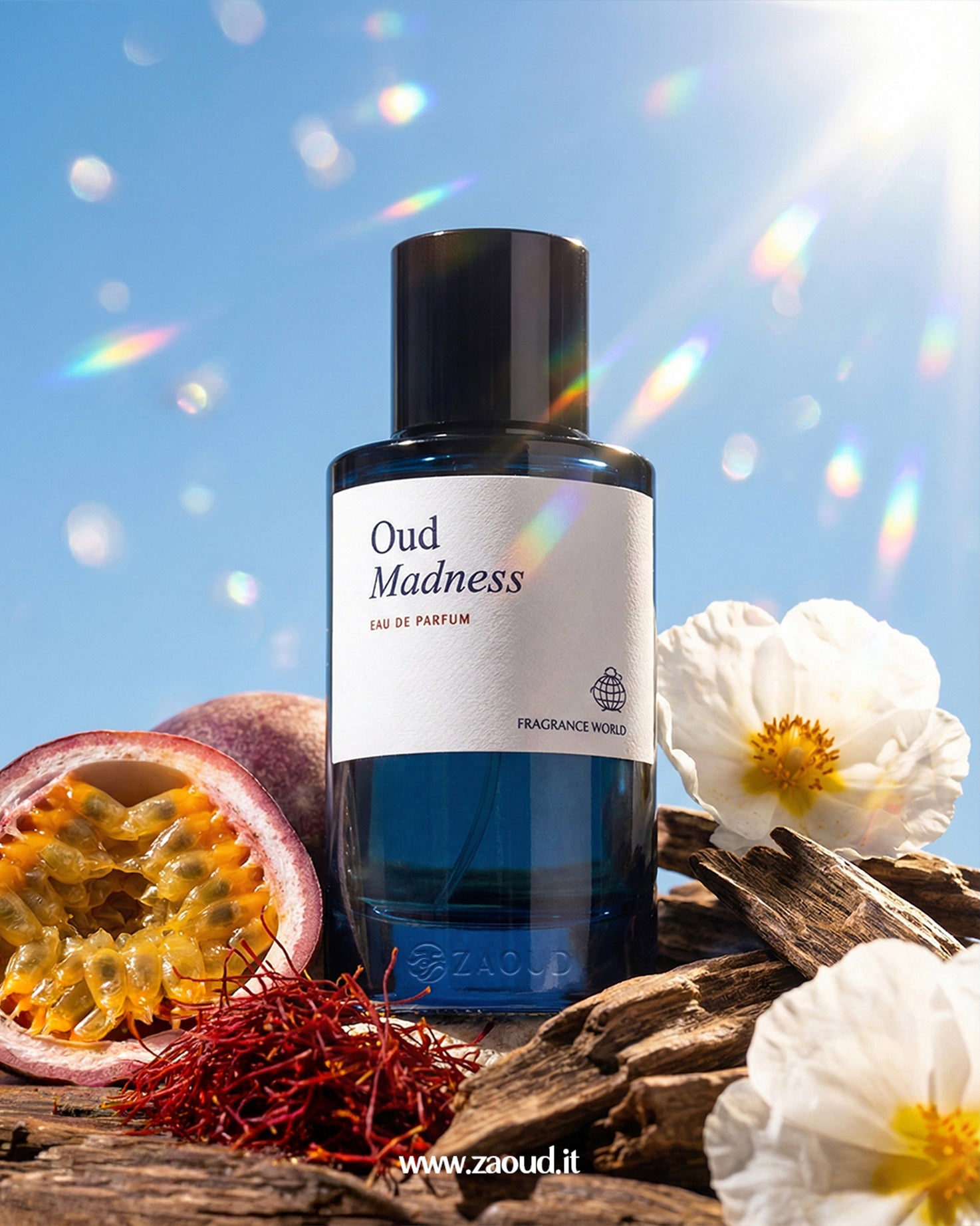 Bottle of 'Oud Madness' perfume with natural elements on a wooden surface against a blue sky.
