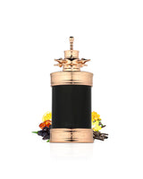 french avenue axis Decorative bottle with gold top and black body surrounded by vanilla and amber on a white background