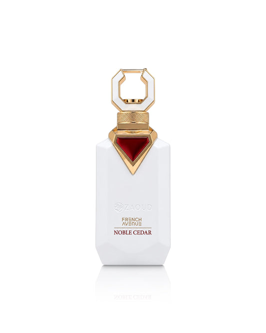 A white rectangular perfume bottle with a gold geometric cap and a red faceted accent on the neck, labeled zaoud French Avenue Noble Cedar, on a white background.