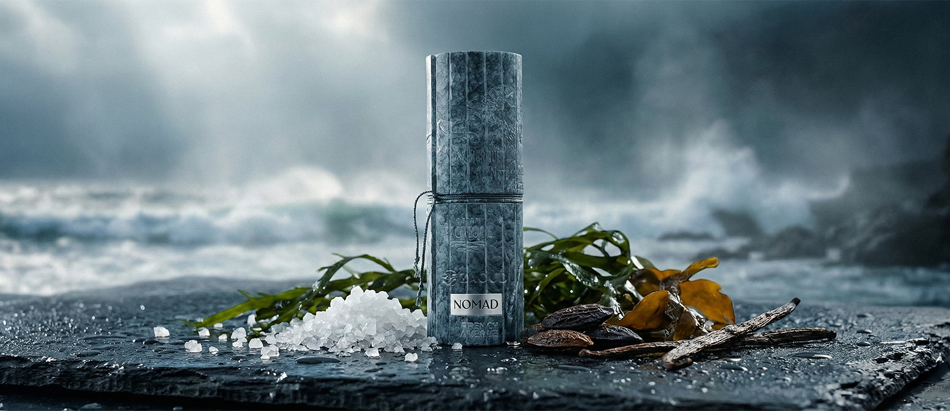 french avenue nomad perfume bottle shows beside salt and tonka beans against sea beach