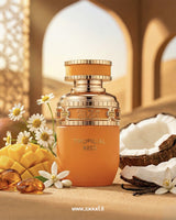 Orange perfume bottle labeled 'Tropical Kiss' with pineapple, coconut, and flowers on a warm-toned background.