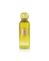A yellow-green glass perfume bottle with a metallic gold cap, featuring a circular silver and gold label that reads 'gissah BEYOND ME' and 'Scent of Life'.