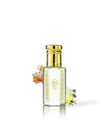hamam perfume oil bottle with a shiny gold cap and gold decorative patterns on the front, filled with a pale yellow liquid. Small white and yellow flowers with orange accents are tucked behind the bottle on a clean white background.