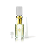hamam perfume oil bottle with gold collar, and gold decorative label, shown on a white background with its cap off and a small applicator wand beside it.