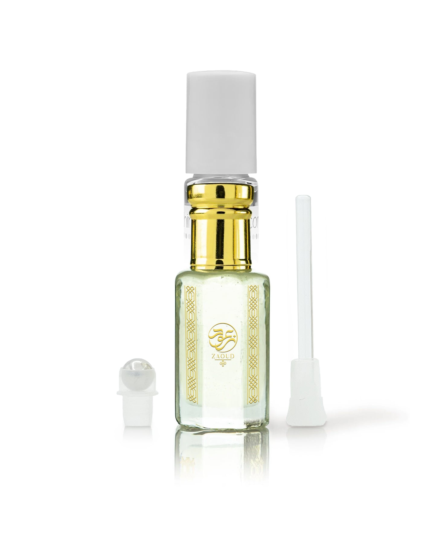 hamam perfume oil bottle with gold collar, and gold decorative label, shown on a white background with its cap off and a small applicator wand beside it.