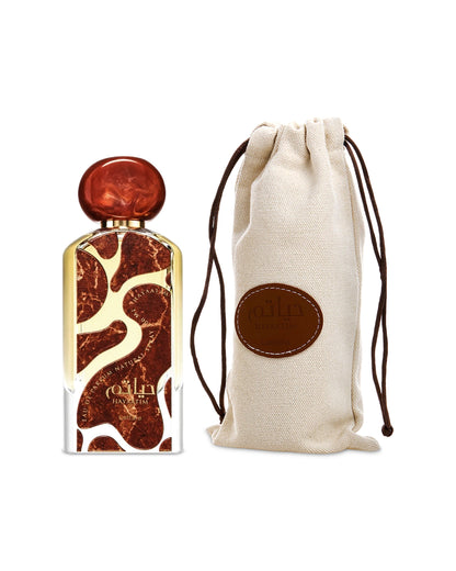 hayaatim by lattafa perfumes bottle shows beside its packeging pouch against white background