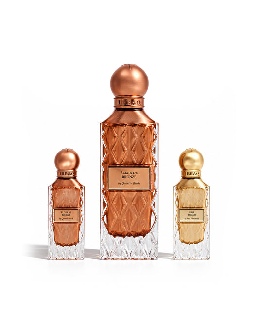 Ibraq elixir de bronze twilight secret set with dor tresor perfume bottles shows against white backgroound