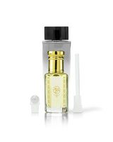 kaleema perfume oil bottle with golden cap beside roller and stick with kalemat perfume bottle behind against white background