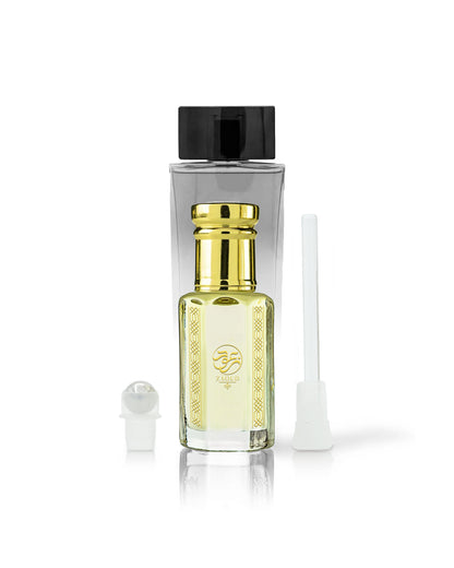 kaleema perfume oil bottle with golden cap beside roller and stick with kalemat perfume bottle behind against white background