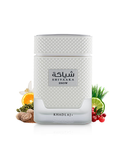 khadlaj shiyaaka snow perfume bottle surrounded by fragrance notes like nutmeg and citrus shows against white background