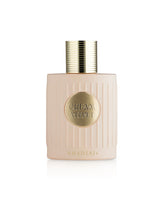 A pale blush pink ribbed bottle of Khadlaj Cream Velvet perfume with a gold cap and a gold circular label on the front, set against a clean white background.