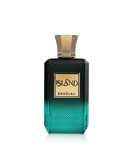 A rectangular fragrance bottle with a textured gradient from black at the top to teal-green at the bottom, featuring a gold-toned cap and a gold label that reads 'khadlaj ISLAND'.