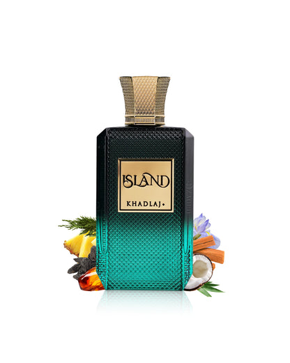 A rectangular perfume bottle labeled KHADLAJ ISLAND, with a black-to-teal gradient textured body and a gold cap, styled with tropical ingredients like lemongrass, citrus, cinnamon, and a coconut on a white background.